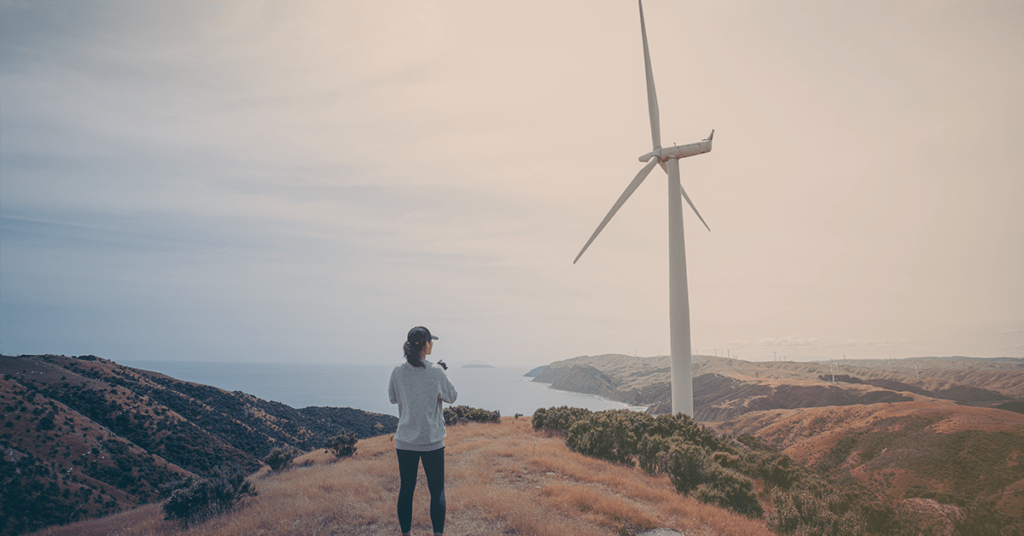 lady looking at sustainable windturbine
