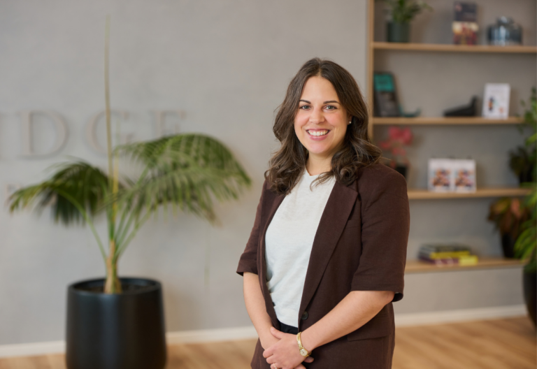 Smiling professional woman standing in modern office