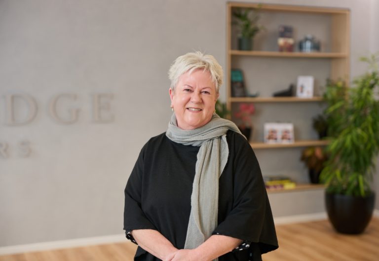 Smiling woman standing in a modern office lobby