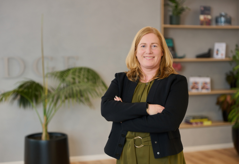 Confident professional woman smiling in modern office